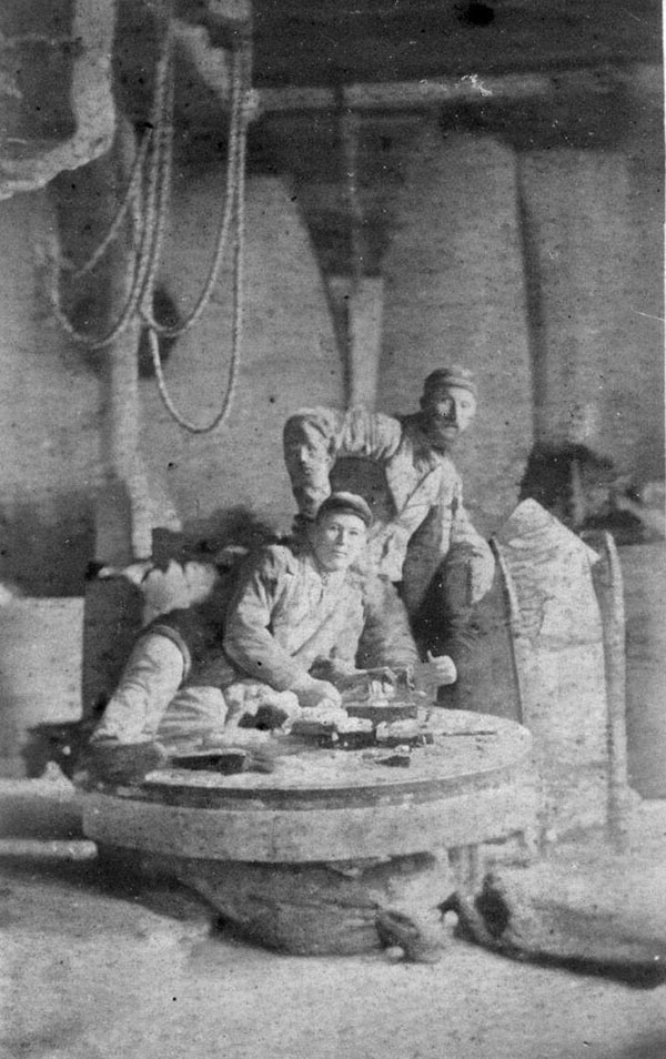 Joel Roger Carter IV on the Dotton Mill grinding stone